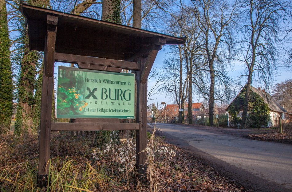 Place name sign in Spreewald in the background a road